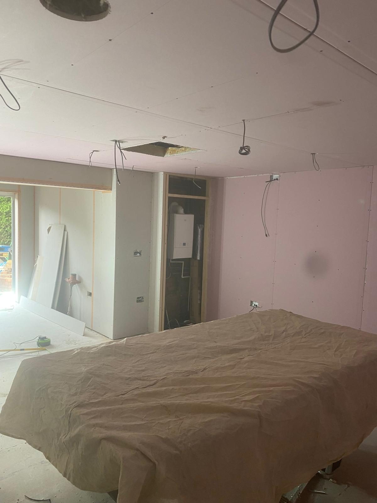 Drylining project — pink plasterboard walls and ceiling