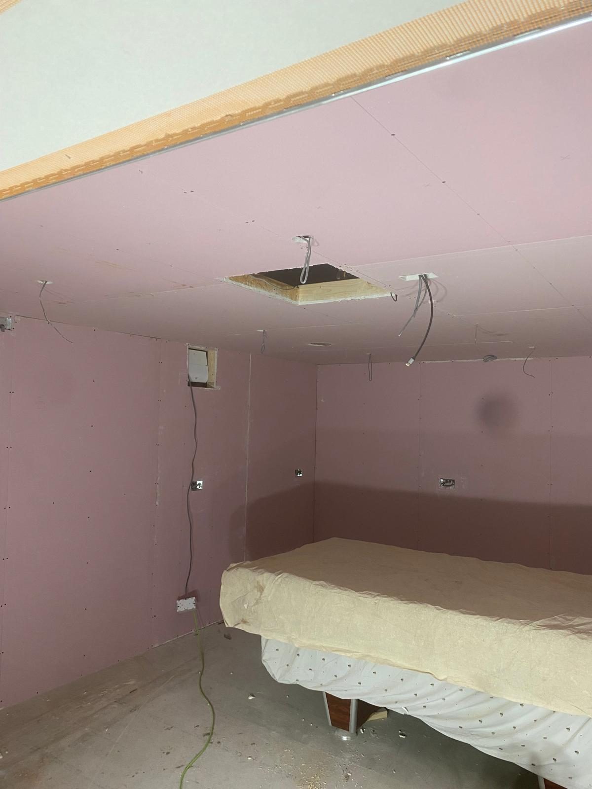 Drylined bedroom with fresh plasterboard installation